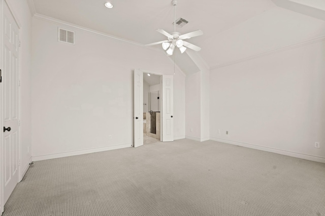 carpeted empty room with ceiling fan, ornamental molding, and lofted ceiling