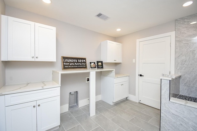 7618 Highmeadow Dr, Houston, TX 77063 - laundry area with cabinet space, recessed lighting, and light tile patterned floors