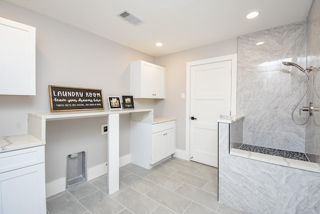 7618 Highmeadow Dr, Houston, TX 77063 - laundry room featuring cabinet space, recessed lighting, hookup for a washing machine, and light tile patterned floors
