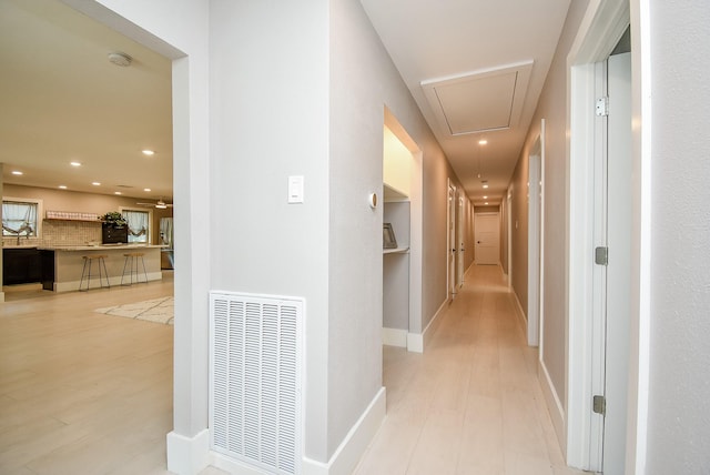 7618 Highmeadow Dr, Houston, TX 77063 - hall with attic access, light wood finished floors, and recessed lighting