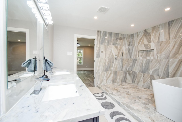 bathroom with shower with separate bathtub, vanity, and hardwood / wood-style floors