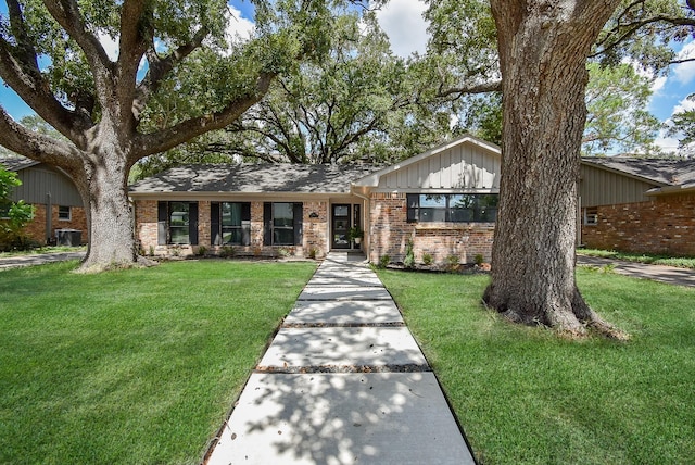 single story home with a front lawn and cooling unit