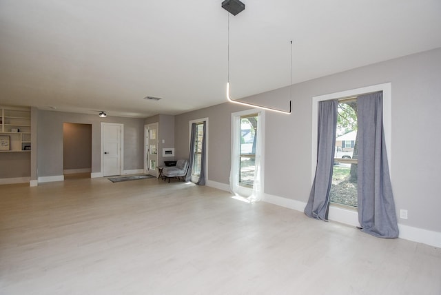 unfurnished living room with light wood-type flooring