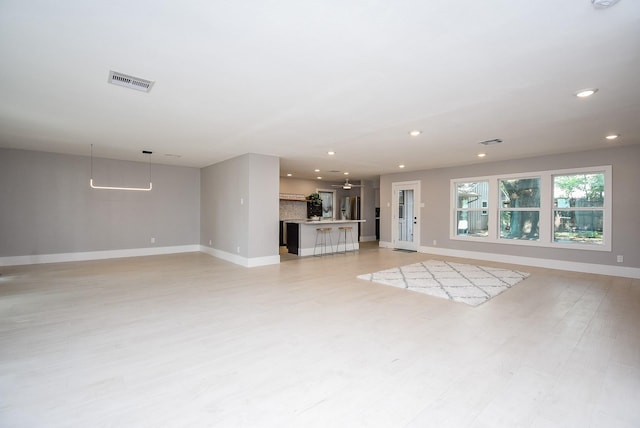 unfurnished living room featuring light wood-type flooring