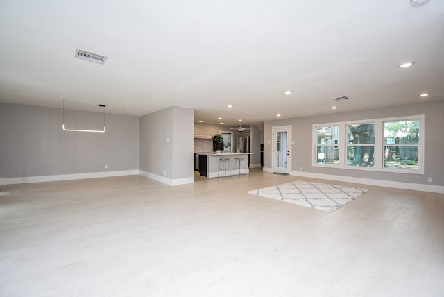 7618 Highmeadow Dr, Houston, TX 77063 - unfurnished living room with recessed lighting and light wood finished floors