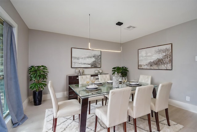 dining space with light hardwood / wood-style flooring