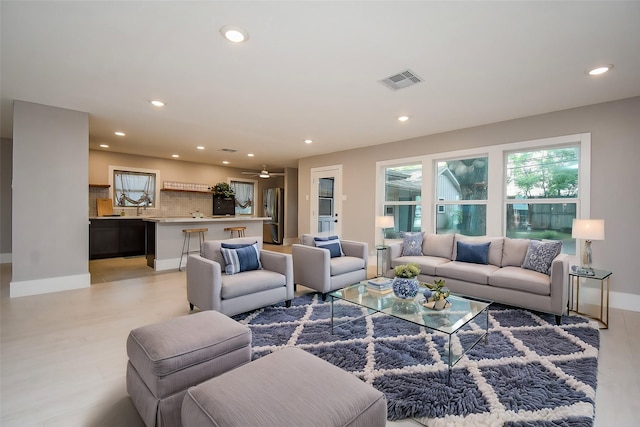 living room featuring ceiling fan and light wood-type flooring