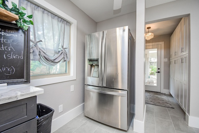 7618 Highmeadow Dr, Houston, TX 77063 - kitchen with stainless steel refrigerator with ice dispenser, light stone counters, and light tile patterned floors