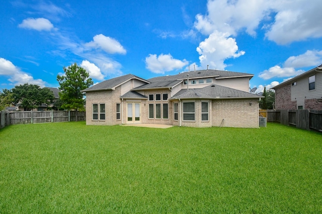 rear view of house featuring a lawn