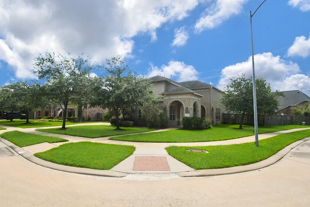 mediterranean / spanish house featuring a front lawn