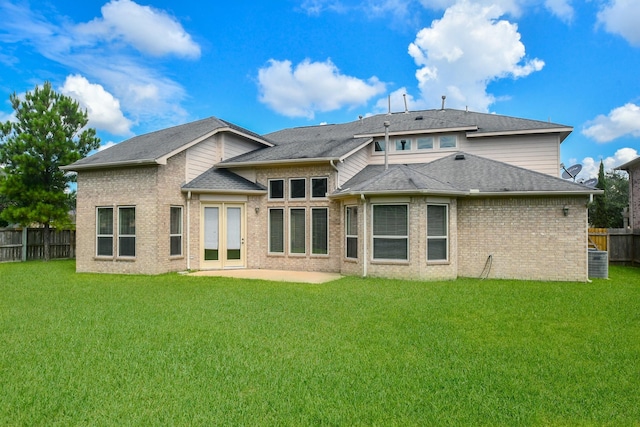 rear view of house featuring a patio, cooling unit, and a lawn