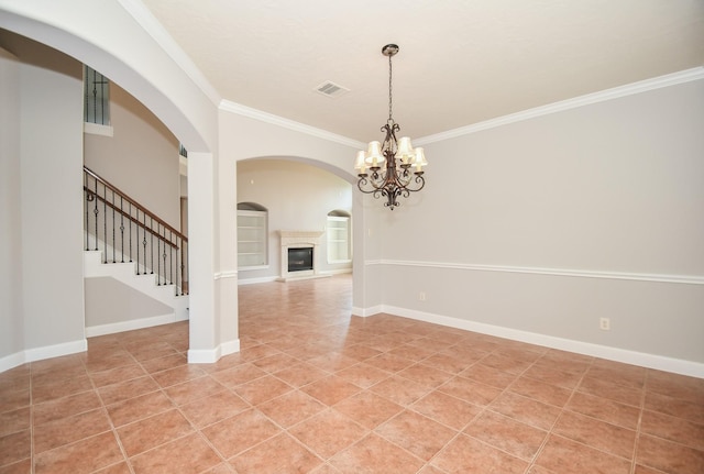 tiled empty room featuring ornamental molding and an inviting chandelier