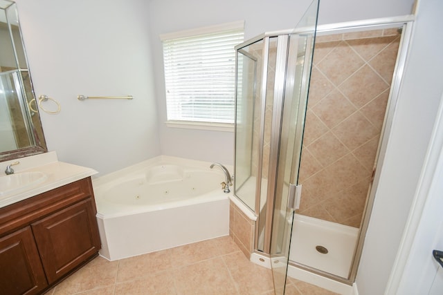 bathroom featuring tile patterned floors, vanity, and shower with separate bathtub