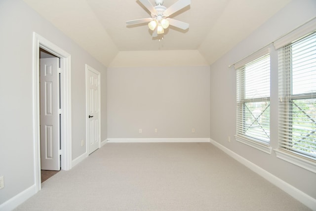 spare room featuring ceiling fan, carpet floors, and lofted ceiling