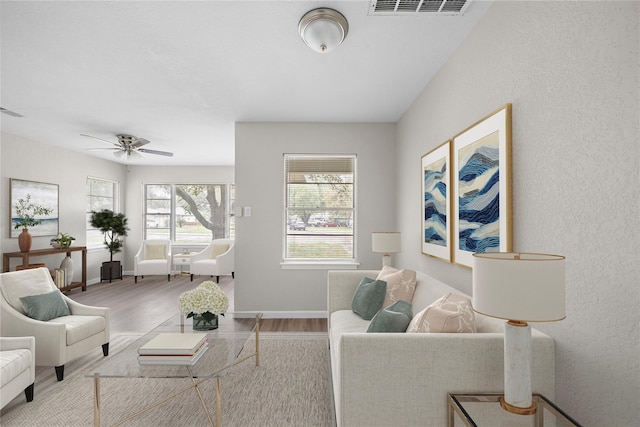 living room featuring hardwood / wood-style floors and ceiling fan