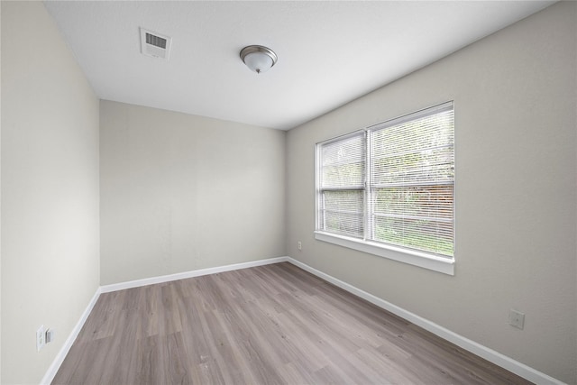 unfurnished room featuring light hardwood / wood-style floors