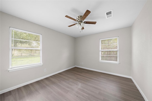 spare room featuring hardwood / wood-style floors and ceiling fan