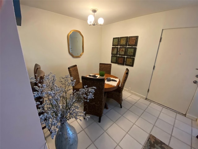 dining space featuring light tile patterned flooring and a chandelier