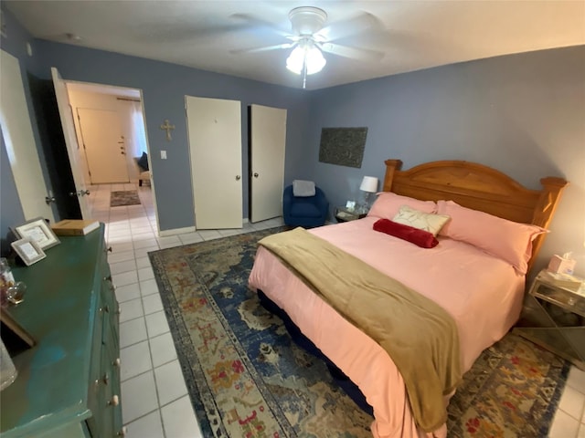 bedroom with ceiling fan and light tile patterned floors