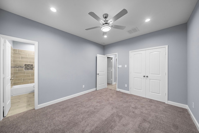 unfurnished bedroom featuring connected bathroom, ceiling fan, a closet, and light carpet