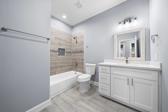 full bathroom with vanity, toilet, and tiled shower / bath