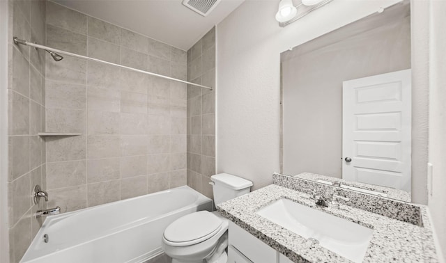 full bathroom featuring vanity, toilet, and tiled shower / bath