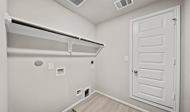 clothes washing area featuring electric dryer hookup, hookup for a gas dryer, hookup for a washing machine, and light hardwood / wood-style flooring