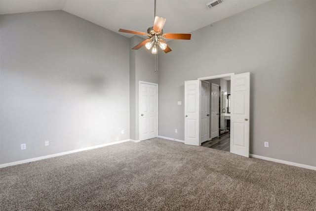 unfurnished bedroom with dark colored carpet, ceiling fan, and high vaulted ceiling