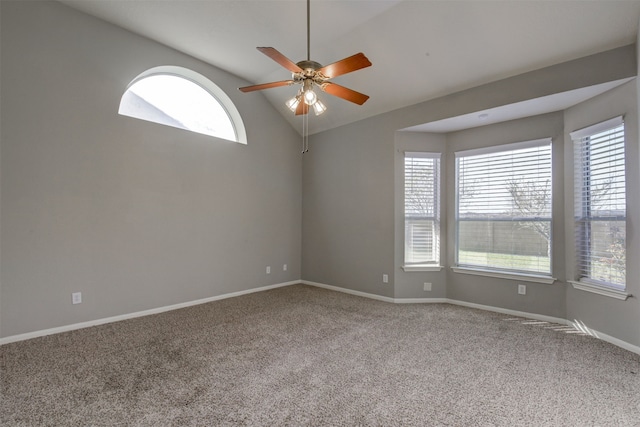 carpeted empty room with a wealth of natural light, lofted ceiling, and ceiling fan