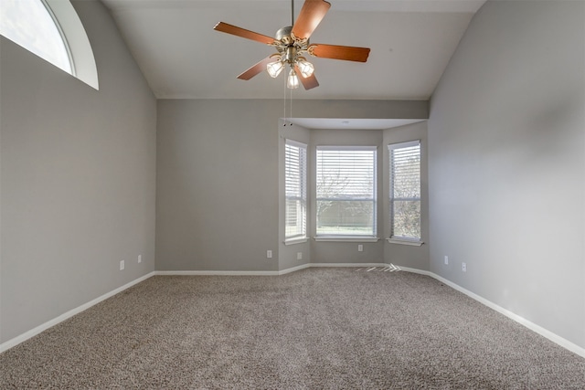 carpeted empty room with ceiling fan and lofted ceiling