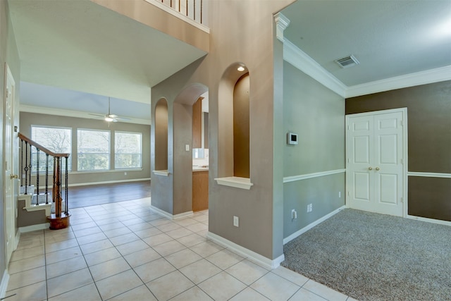 interior space featuring ceiling fan and ornamental molding