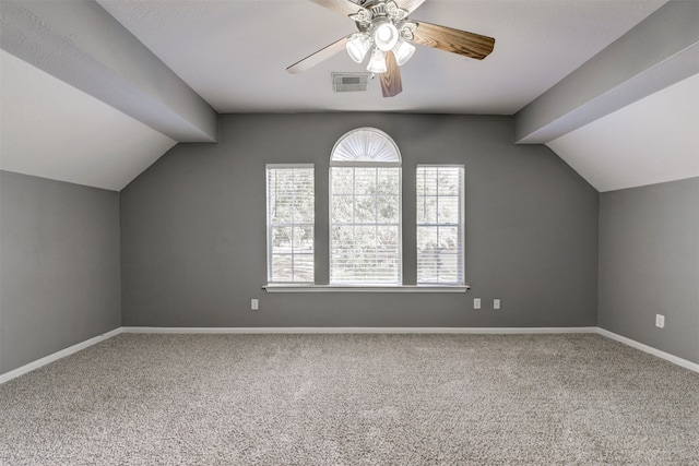 additional living space featuring ceiling fan, carpet floors, and lofted ceiling with beams