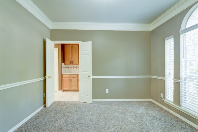 unfurnished room with light carpet and crown molding