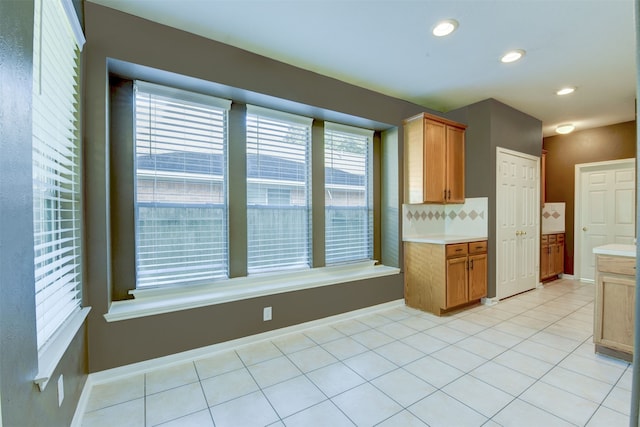 kitchen with decorative backsplash and light tile patterned floors