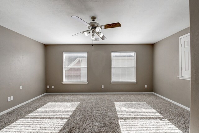 empty room with ceiling fan and light colored carpet