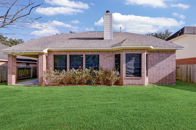 back of property featuring a lawn