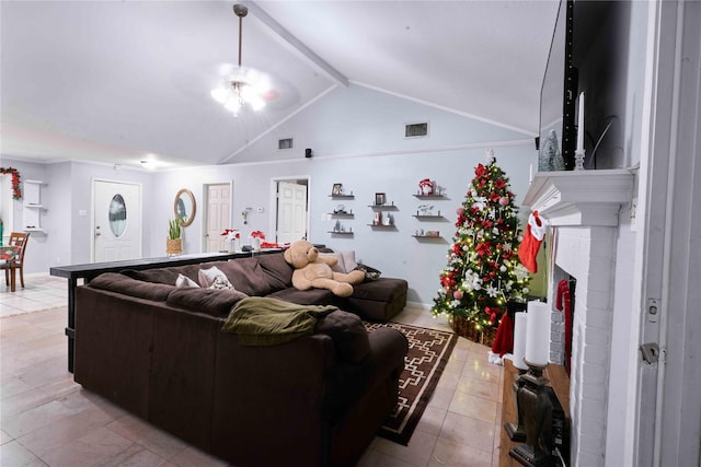 living room featuring vaulted ceiling with beams, light tile patterned floors, and a brick fireplace