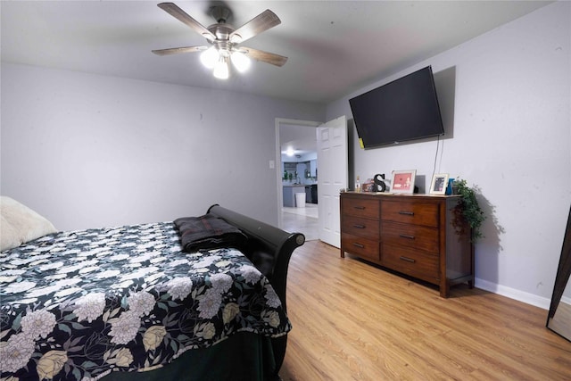 bedroom with light hardwood / wood-style floors and ceiling fan