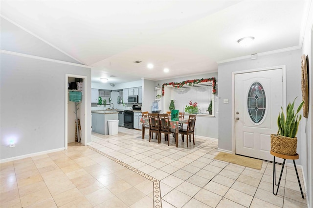 tiled foyer entrance featuring ornamental molding and sink