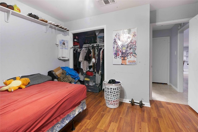 bedroom with hardwood / wood-style flooring and a closet