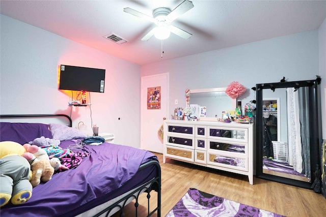 bedroom with ceiling fan and light hardwood / wood-style flooring