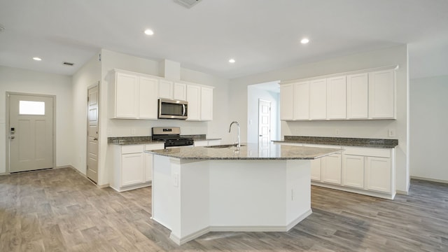 kitchen featuring white cabinets, appliances with stainless steel finishes, and sink