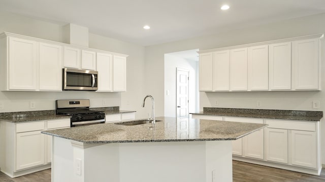 kitchen with white cabinetry, sink, light wood-type flooring, and appliances with stainless steel finishes