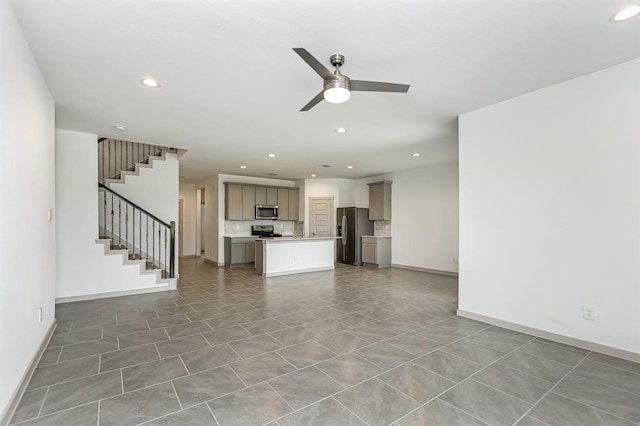 unfurnished living room featuring recessed lighting, stairway, ceiling fan, baseboards, and tile patterned floors