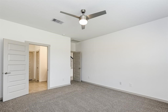 unfurnished bedroom with carpet, visible vents, and baseboards