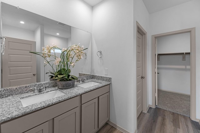 6605 Alexis St, Beaumont, TX 77708 - full bath featuring double vanity, wood finished floors, a spacious closet, and a sink