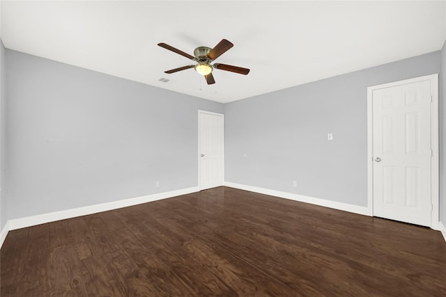 unfurnished room with dark hardwood / wood-style floors and ceiling fan