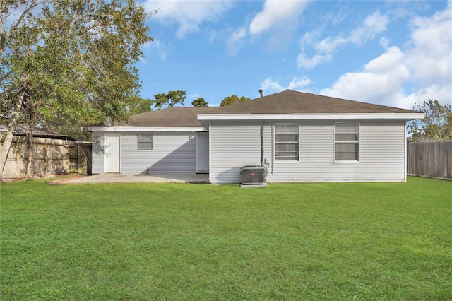 back of house with a yard and central AC unit