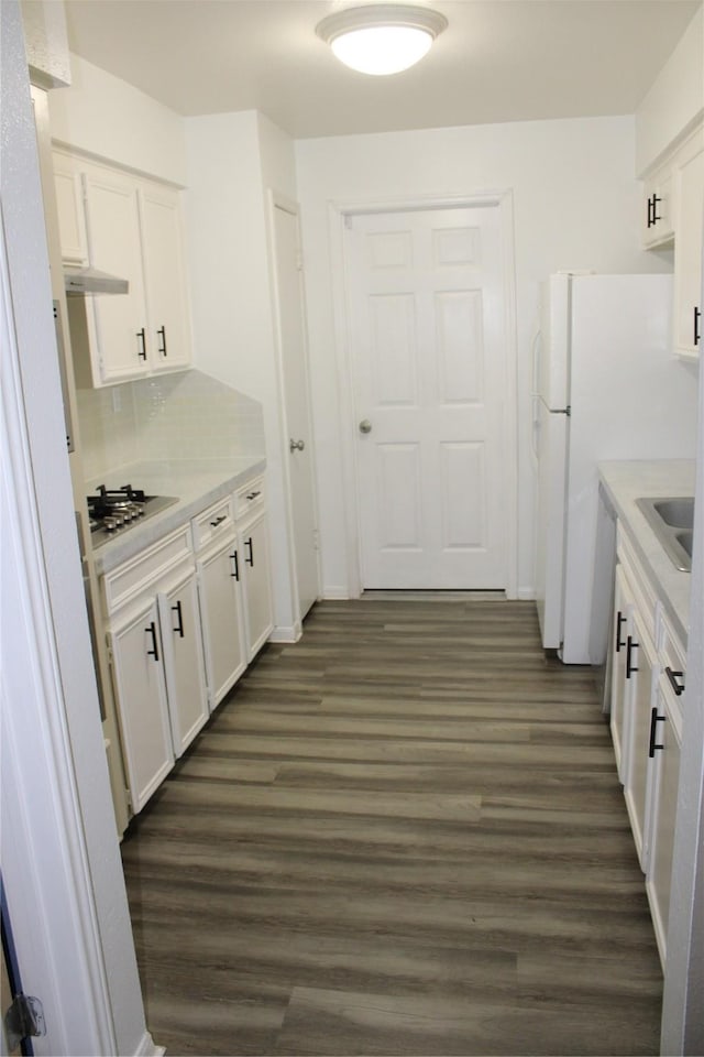 kitchen with white dishwasher, white cabinets, dark hardwood / wood-style floors, and stainless steel gas stovetop