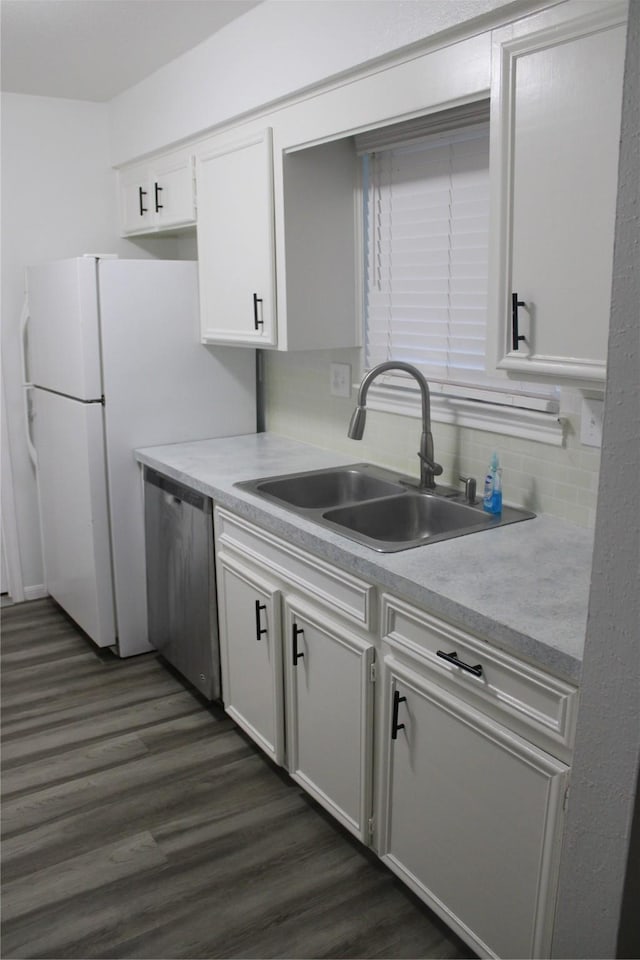 kitchen with white cabinetry, sink, stainless steel dishwasher, and dark hardwood / wood-style floors